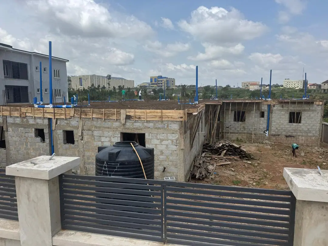 Blockwork walls rising behind a finished charcoal gate