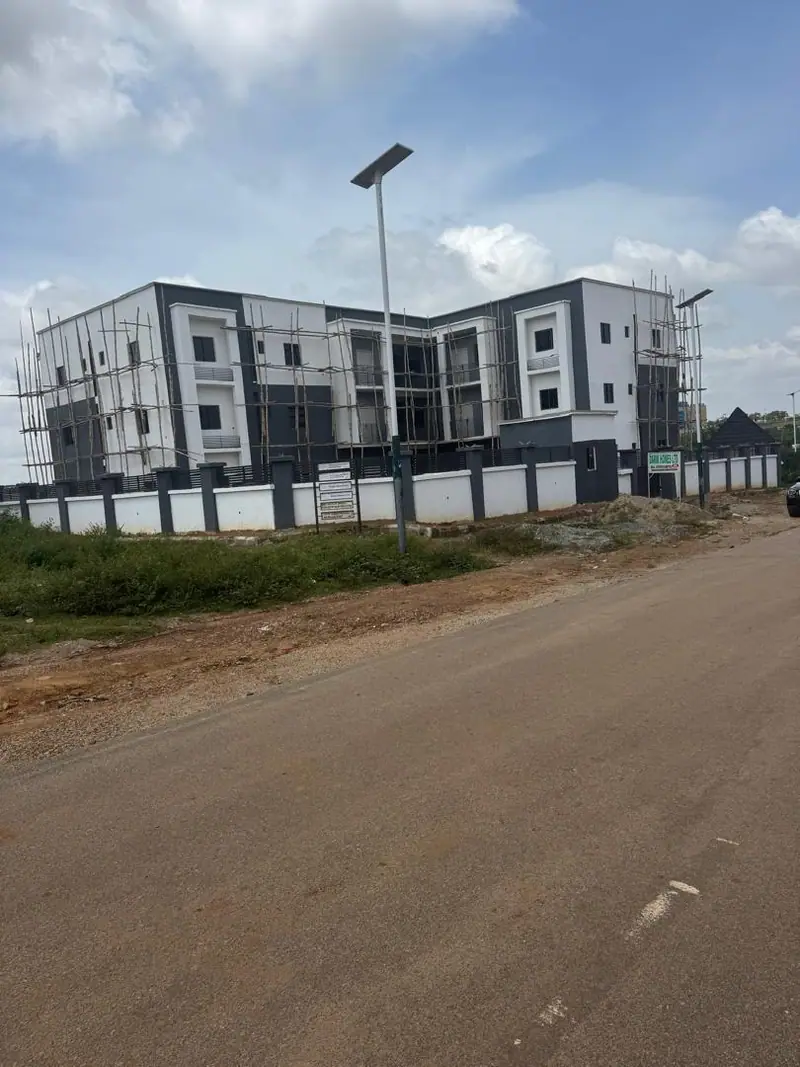 The walled frontage of the Kaura block seen from the road