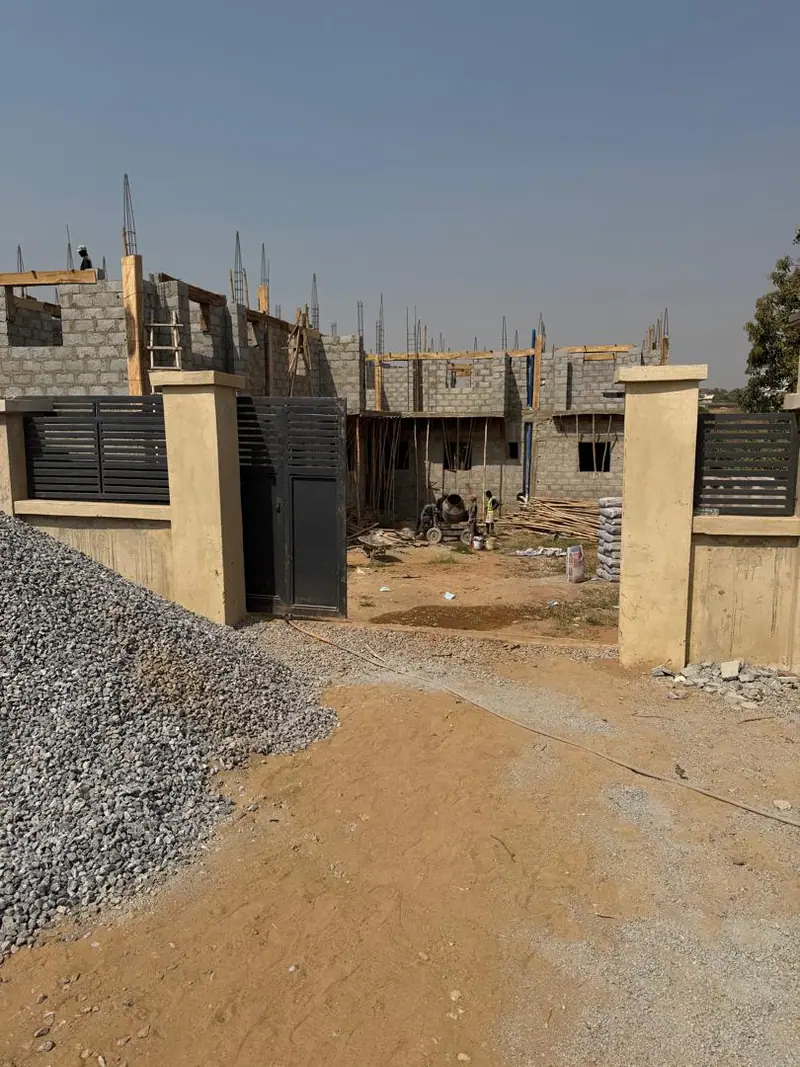 Aggregate heaped at the entrance of a Darik Homes construction site