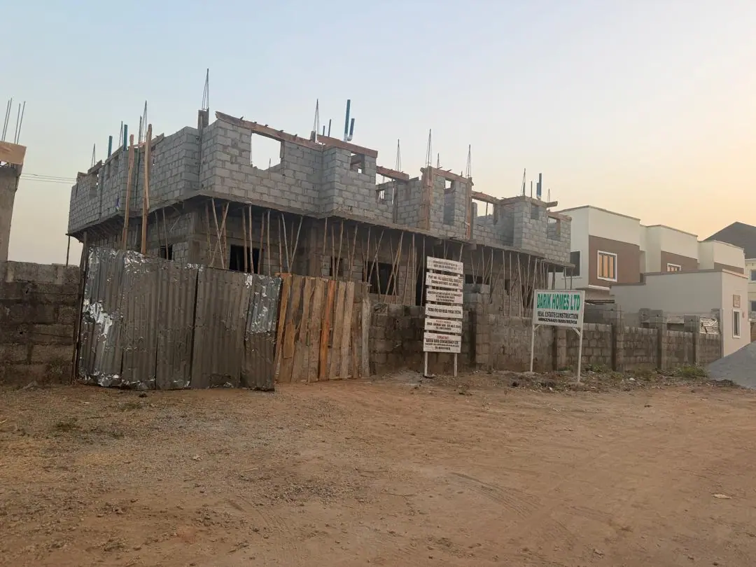 A concrete structure under construction at dusk
