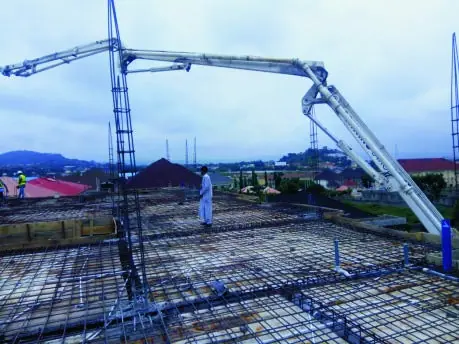 A concrete pump boom placing concrete on a reinforced slab