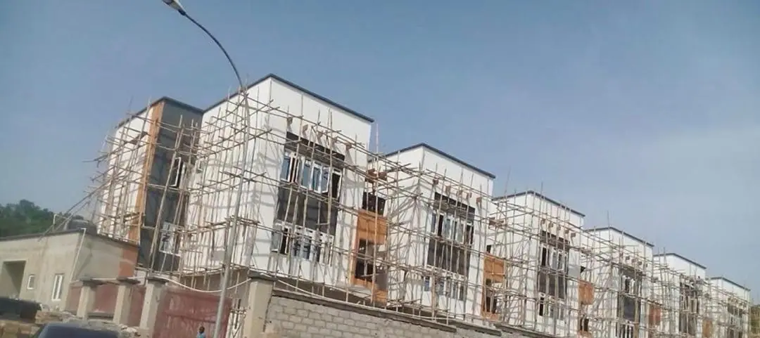A row of terrace houses wrapped in timber scaffolding